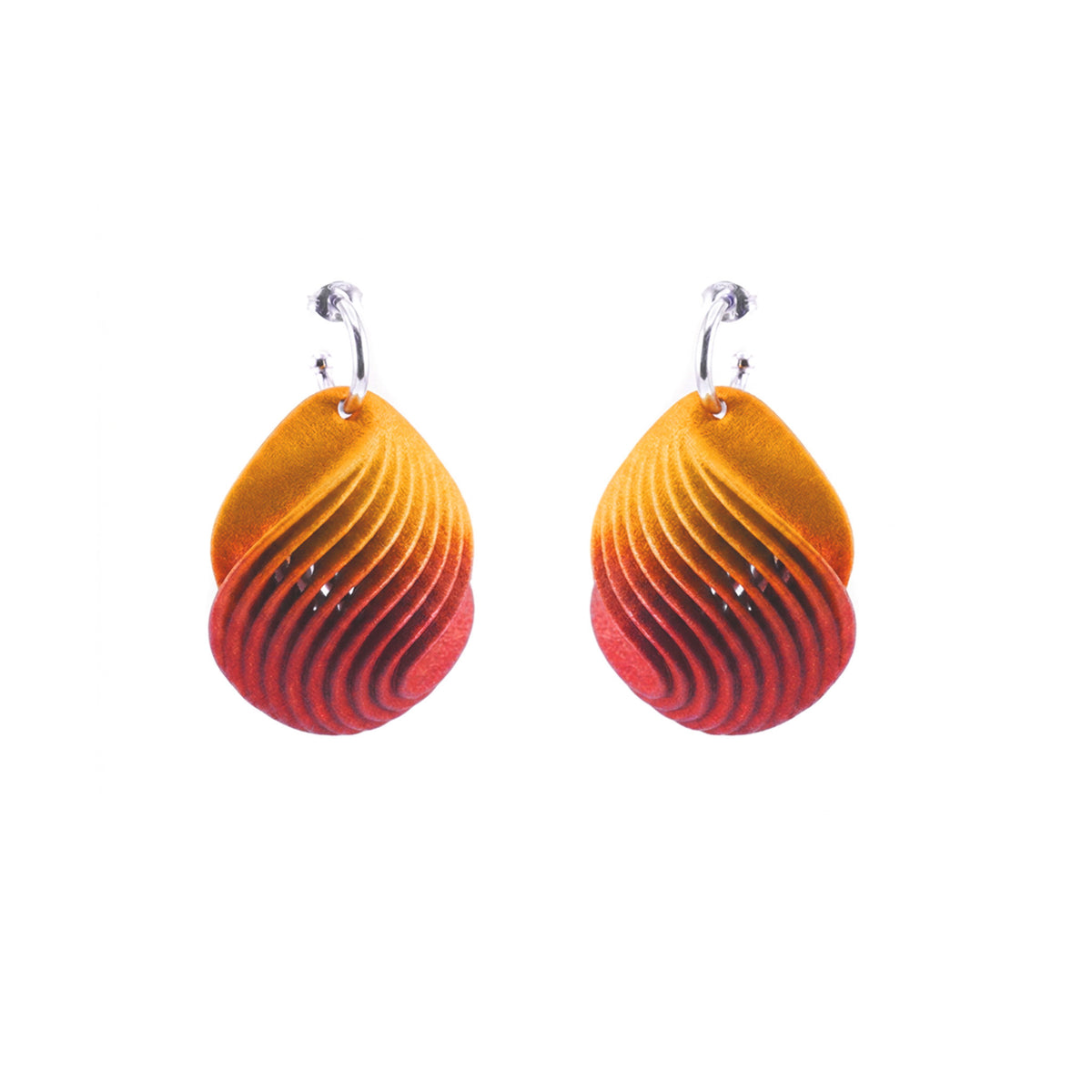 Orange petal shaped drop earrings with a layered design on a silver hoop on a white background