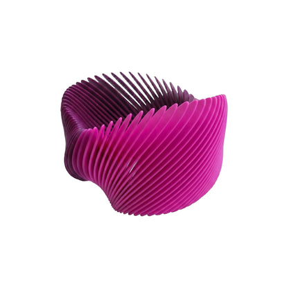 Pink gradient 3D printed flexible nylon bangle cuff by Phase Jewellery on white background.